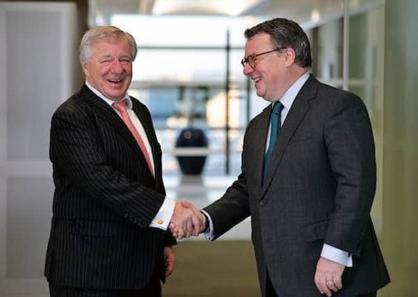 Aberdeen Asset Management chief Martin Gilbert, left, shakes hands on the deal with Standard Life boss Keith Skeoch. Picture: Graham Flack