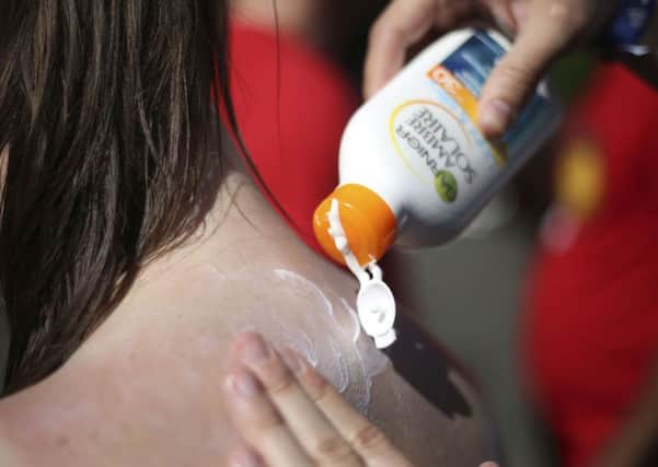 Slathering on sunscreen could be one of the factors behind people becoming vitamin D deficient, a new study suggests. Picture: Philip Toscano/PA Wire