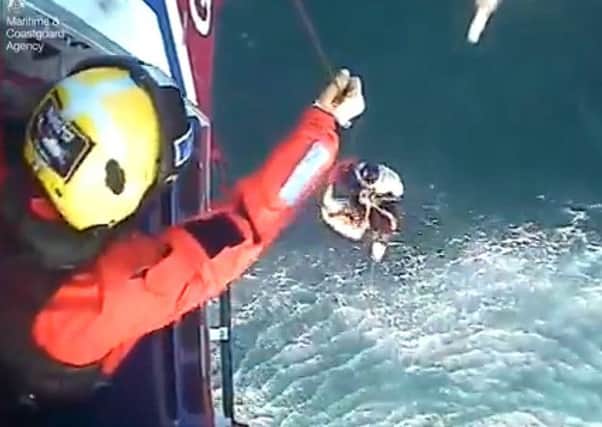 The moment surfer Matthew Bryce, who survived more than 30 hours stranded at sea on his board, was rescued. Picture: Maritime & Coastguard Agency/PA Wire