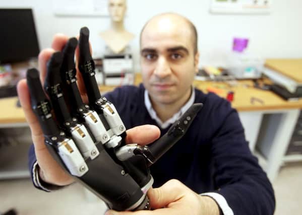 Dr. Kianoush Nazarpour with a new bionic hand that "sees" objects. Picture: Mike Urwin/Newcastle University/PA Wire