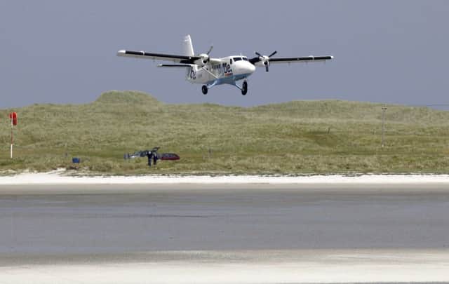 A Loganair Twin Otter aircraft lands at Barra airport on Traigh Mhor beach, which has been named one of the world's most scenic landings in a travel poll. Picture: Allan Milligan
