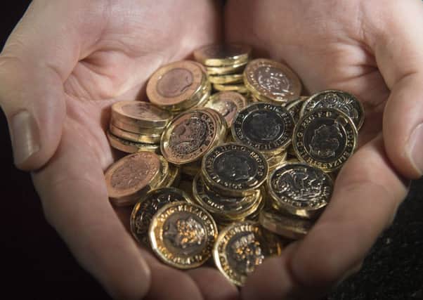 New one pound coins are entering circulation with holes and blemishes. Picture: PA