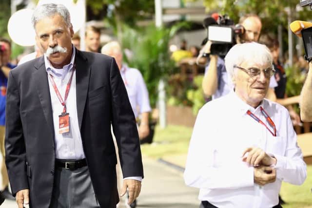 Chase Carey, left, walks with Bernie Ecclestone in the paddock at last Septembers Singapore Grand Prix. Picture Lars Baron/Getty Images