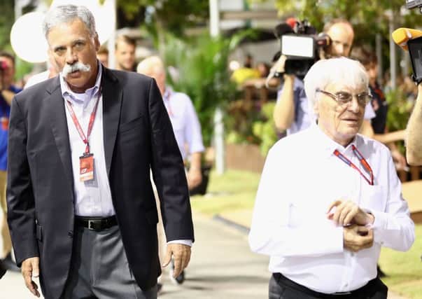 Chase Carey, left, walks with Bernie Ecclestone in the paddock at last Septembers Singapore Grand Prix. Picture Lars Baron/Getty Images