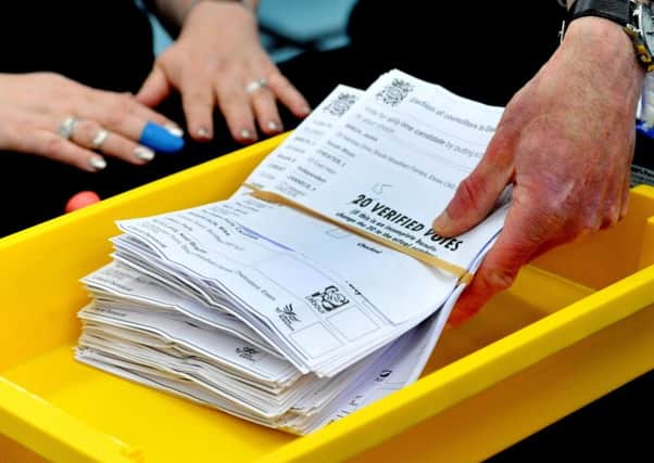 Verified ballot papers are collected from a tray at the local election count in Chelmsford, Essex. Picture: PA