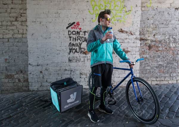 Deliveroo riders have to put down a deposit for their uniforms. Picture: John Devlin