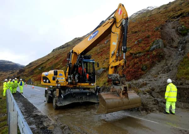 Workers clear the mud from a landslide on the A83 at the Rest and Be Thankful in 2011. Picture: Robert Perry