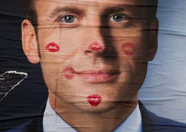 A defaced poster for Emmanuel Macron in Paris. Picture: JOEL SAGET/AFP/Getty Images)