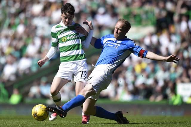 Celtic debutant Michael Johnston is tackled by Steven Anderson. Pic: SNS/Craig Williamson
