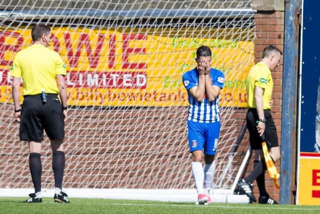 Kilmarnock's Jordan Jones can't bare to watch as assistant referee Andrew McWilliam is sick. Pic: SNS/Sammy Turner