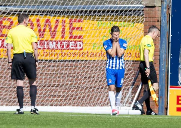 Kilmarnock's Jordan Jones can't bare to watch as assistant referee Andrew McWilliam is sick. Pic: SNS/Sammy Turner