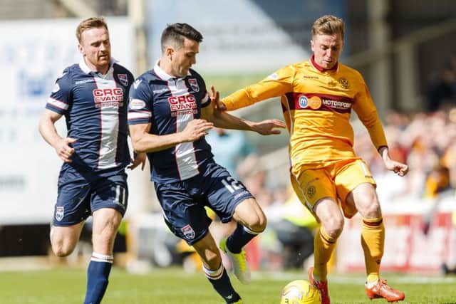 Motherwell's Elliot Frear battles for the ball against Ross County's Tim Chow. Pic: SNS/Roddy Scott