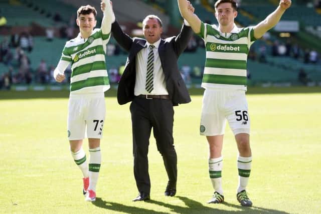 Brendan Rodgers with Michael Johnston, left, and Anthony Ralston. Photograph: Craig Williamson/SNS