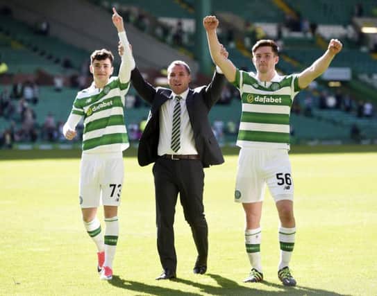 Brendan Rodgers with Michael Johnston, left, and Anthony Ralston. Photograph: Craig Williamson/SNS