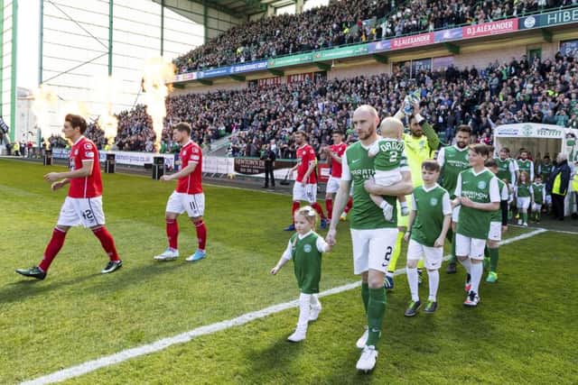 David Gray leads out the Championship champions to fireworks. Pic: SNS/Alan Rennie