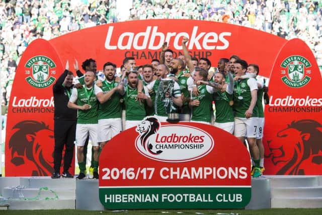 Hibernian celebrate with the Ladbrokes Championship trophy. Pic: SNS/Alan Harvey