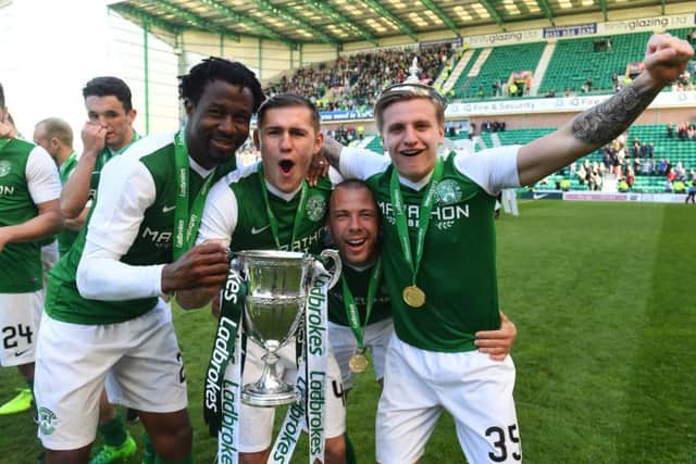 Efe Ambrose, Scott Martin, Jordan Forster and Jason Cummings celebrate with the Ladbrokes Championship trophy. Pic: SNS/Alan Harvey