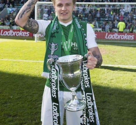 'On my head, son'! Jason Cummings pops the Ladbrokes Championship trophy on his head. Pic: SNS/Alan Harvey