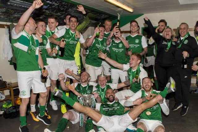 The Hibs players celebrate in the dressing room with the Championship trophy. Picture: SNS