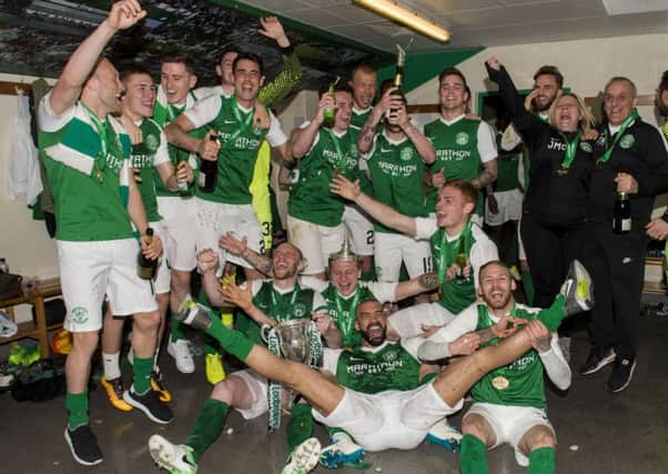 The Hibs players celebrate in the dressing room with the Championship trophy. Picture: SNS