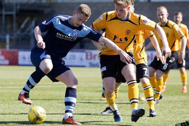 Forfar's Thomas O'Brien battles for the ball against Annan Athletic's Callum Home. Picture: Graham Stuart/SNS
