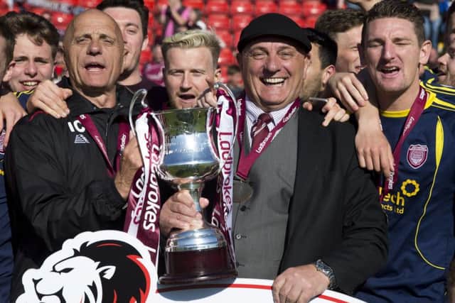 Arbroath manger Dick Campbell is all smiles after his side picked up the League Two trophy. Photograph: Kenny Smith/SNS