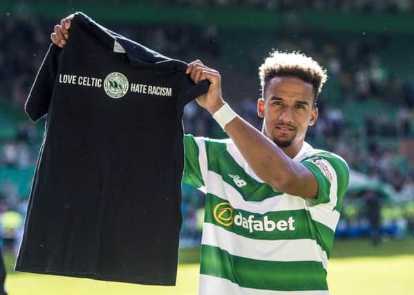 Scott Sinclair displays the t-shirt given to him by Celtic fans. Pic: SNS/
