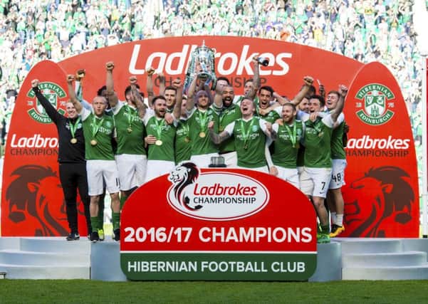 Hibernian celebrate with the Ladbrokes Championship trophy. Picture: SNS