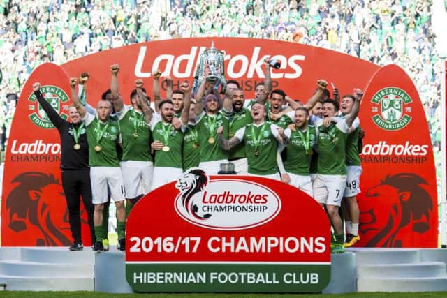 Hibernian celebrate with the Ladbrokes Championship trophy. Picture: SNS