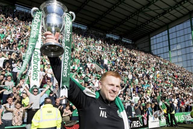 Neil Lennon holds the Championship trophy aloft. Pic: SNS
