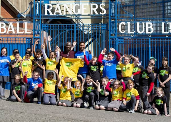 Wes Foderingham and Paul Mortimer with pupils of St Saviours Primary School, where Kick it Out held an anti-discrimination workshop.