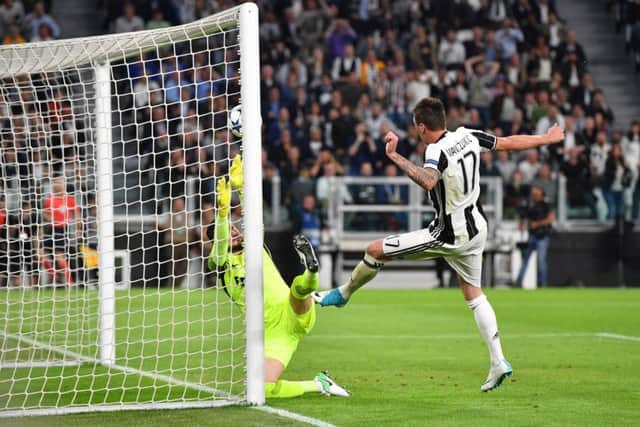 Mario Mandzukic scores Juventuss first goal against Monaco last night. Picture: Getty.