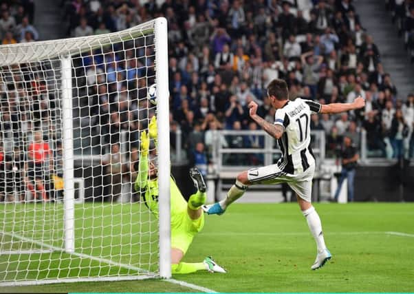 Mario Mandzukic scores Juventuss first goal against Monaco last night. Picture: Getty.
