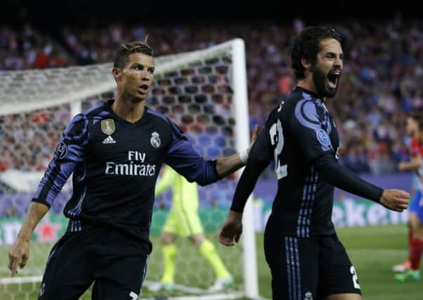 Isco, right, celebrates with Cristiano Ronaldo after scoring for Real Madrid. Picture: AP.