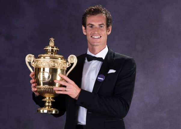 Andy Murray shows off his Wimbledon trophy at the champions diinner last year. Photograph: Getty Images