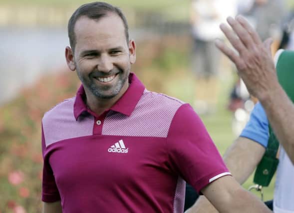 Sergio Garcia is congratulated by fans as he walks to the 17th green after his hole-in-one in the opening round of the Players Championship. Picture: AP
