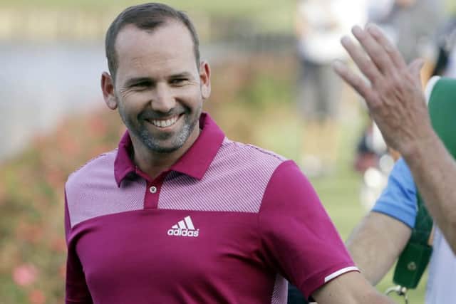 Sergio Garcia is congratulated by fans as he walks to the 17th green after his hole-in-one in the opening round of the Players Championship. Picture: AP