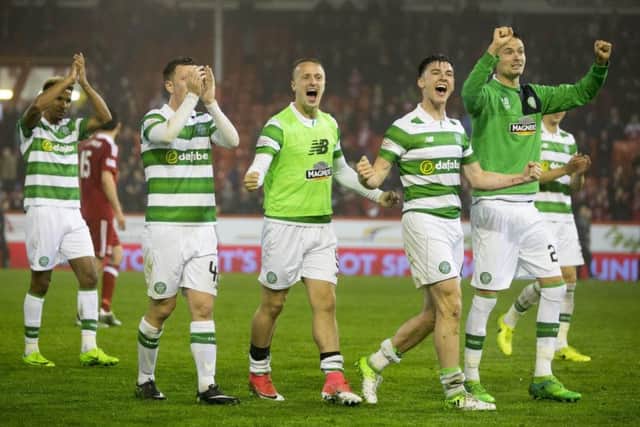 Celtic players celebrate at Pittodrie following the 3-1 win over Aberdeen. Picture: Jeff Holmes/PA Wire
