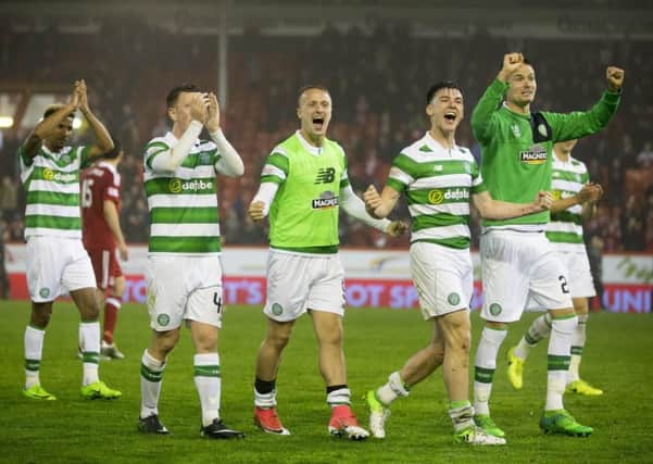 Celtic players celebrate at Pittodrie following the 3-1 win over Aberdeen. Picture: Jeff Holmes/PA Wire