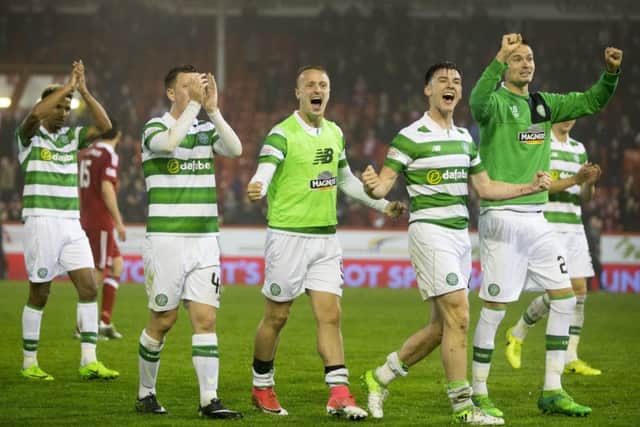 Celtic's Kieran Tierney and Leigh Griffiths lead the celebrations at the final whistle in Aberdeen. Picture: Jeff Holmes/PA Wire.
