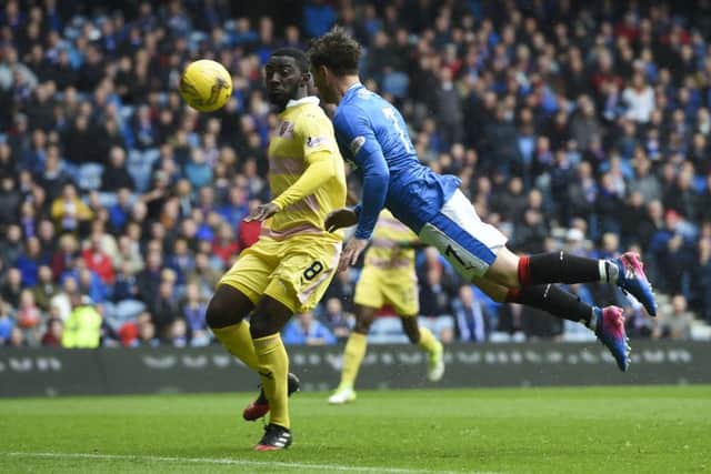 Joe Garner flies through the air to open the scoring at Ibrox. Pic: SNS/Craig Williamson