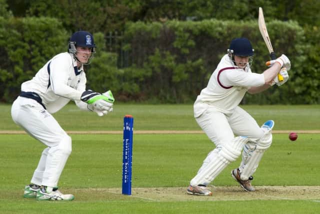 Watsonian Kenny Rae carves the ball away as his side struggled to reach 120 against Heriots. Photograph: Ian Rutherford