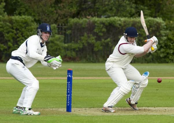 Watsonian Kenny Rae carves the ball away as his side struggled to reach 120 against Heriots. Photograph: Ian Rutherford