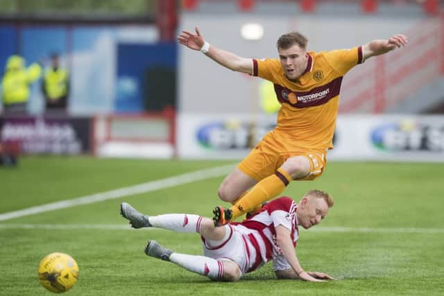 Hamilton's Ali Crawford tackles Motherwell's Chris Cadden. Pic: SNS/Ross Parker