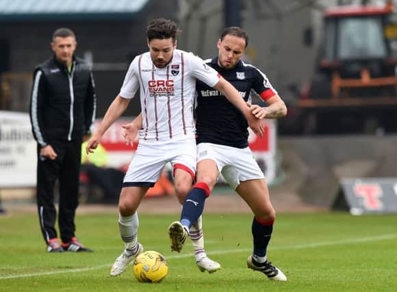 Ross County's Ryan Dow battles with Dundee's Tom Hateley. Pic: SNS/Paul Devlin