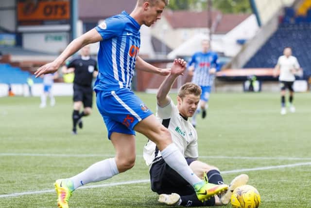 Kilmarnock's Kristoffer Ajer is tackled by Alex Fisher. Pic: SNS/Roddy Scott