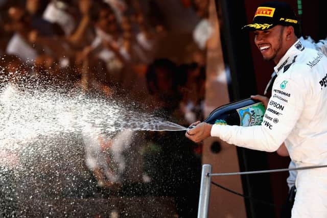 Lewis Hamilton celebrates on the podium following his victory in the Spanish Grand Prix. Picture: Getty.