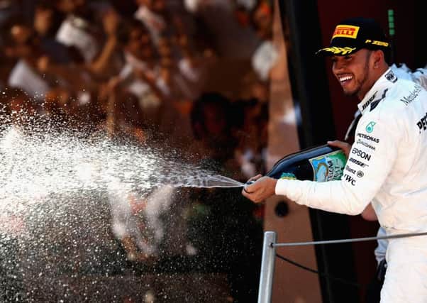 Lewis Hamilton celebrates on the podium following his victory in the Spanish Grand Prix. Picture: Getty.