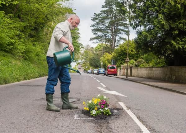 Planting flowers in potholes is becoming a popular way of highlighting the road safety danger. Picture: SWNS