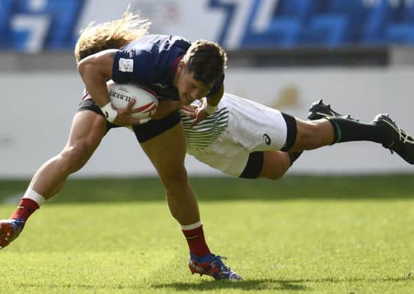 Scotland try-scorer Scott Wight is tackled by South Africa's Glenn Bryce. Picture: AFP/Getty